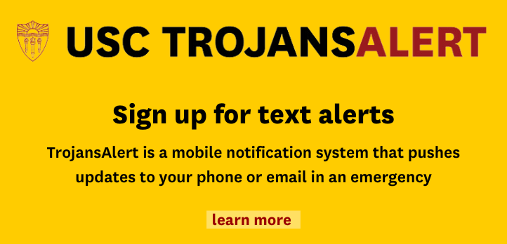 Graphic - Promotional banner for USC TrojansAlert encouraging sign-ups for emergency mobile notifications, featuring a bold yellow background with red text.